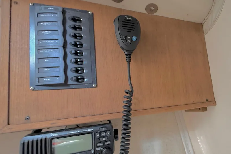 Slide: The Image of 2006 J Boats J/100 control panel with switches and Icom radio handset. - 26
