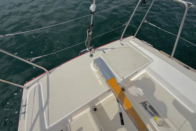 Slide: The Image of 2006 J Boats J/100 sailboat deck with tiller, surrounded by ocean water. - 5