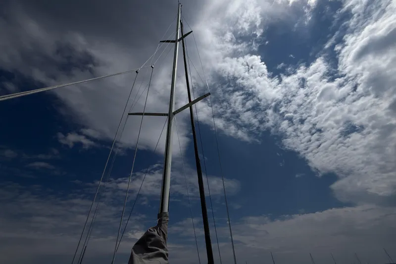 Slide: The Image of Sailboat mast of 2006 J Boats J/100 against a partly cloudy sky. - 11