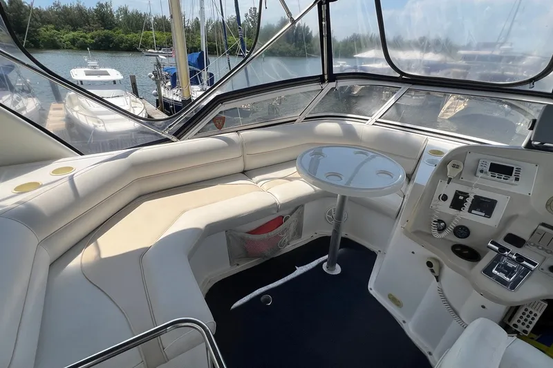 Slide: The Image of 1998 Cruisers Yachts 3650 Aft Cabin interior with helm, seating, and table. - 10