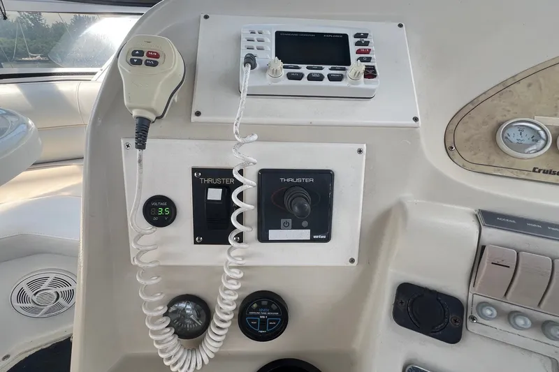 Slide: The Image of 1998 Cruisers Yachts 3650 Aft Cabin helm controls with thruster and voltage display. - 12