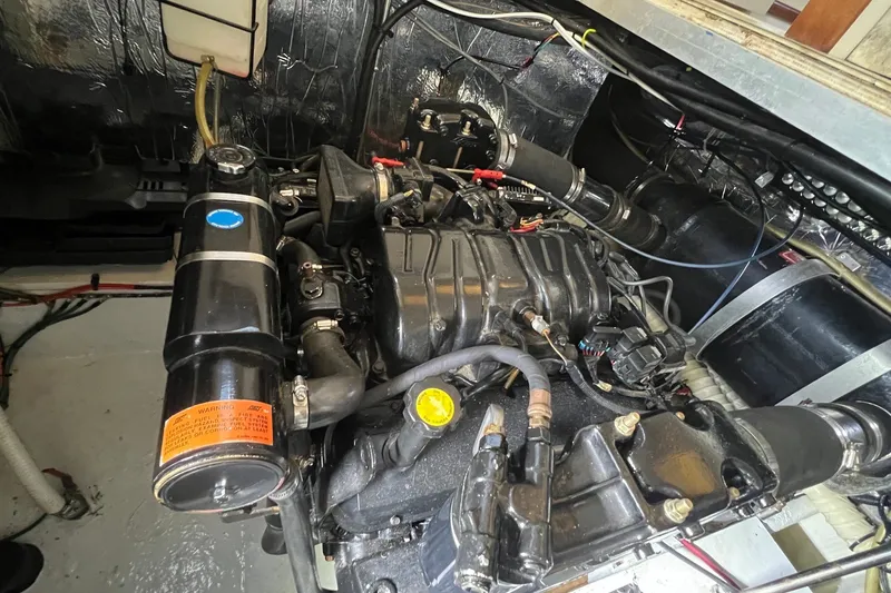 Slide: The Image of Engine compartment of a 1998 Cruisers Yachts 3650 Aft Cabin, showcasing detailed mechanical components. - 19