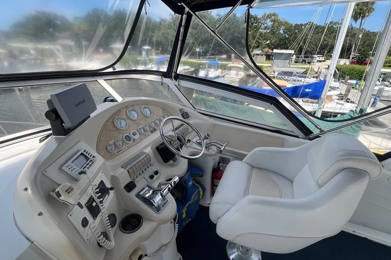 Slide: The Image of Cockpit of 1998 Cruisers Yachts 3650 Aft Cabin with steering wheel and navigation equipment. - 11