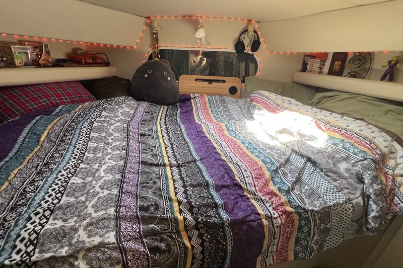 Slide: The Image of Cozy cabin interior of 1998 Cruisers Yachts 3650 Aft, with colorful bedding and decor. - 40