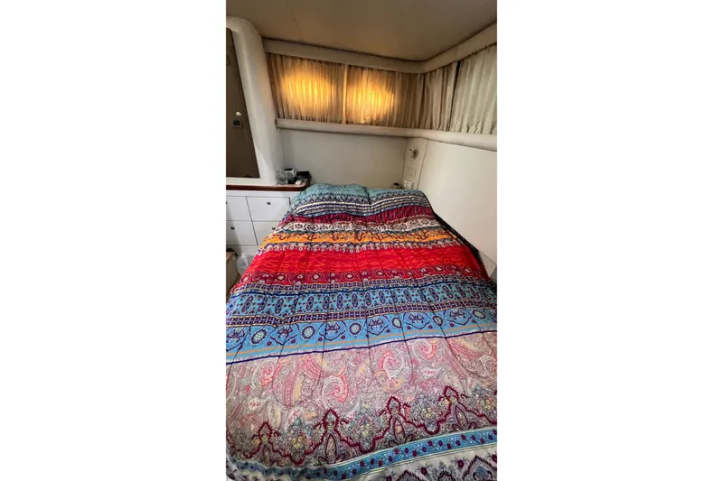 Slide: The Image of 1998 Cruisers Yachts 3650 Aft Cabin bedroom with colorful patterned bedding. - 42