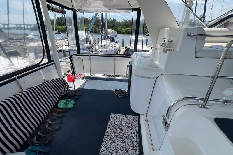 Slide: The Image of 1998 Cruisers Yachts 3650 Aft Cabin interior with striped seating and marina view. - 14