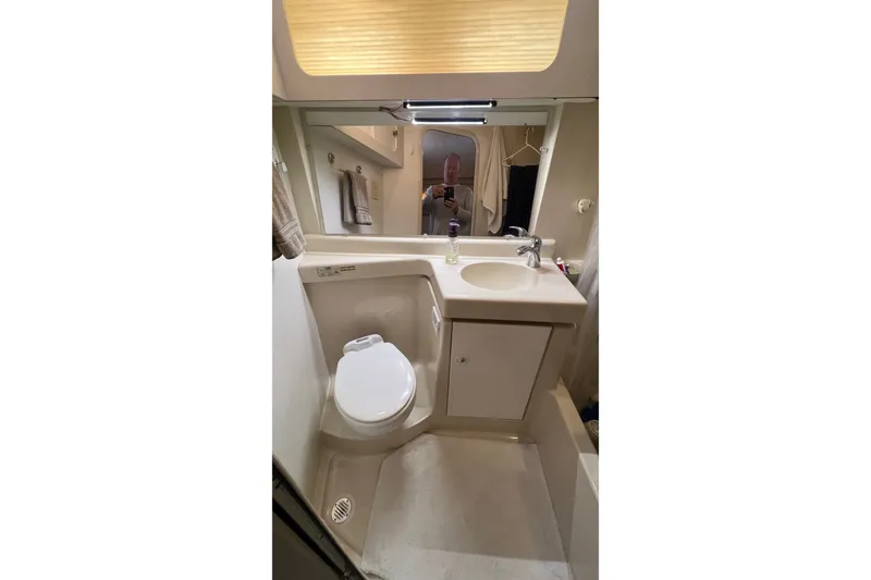 Slide: The Image of 1998 Cruisers Yachts 3650 Aft Cabin bathroom with sink, toilet, and mirror. - 44