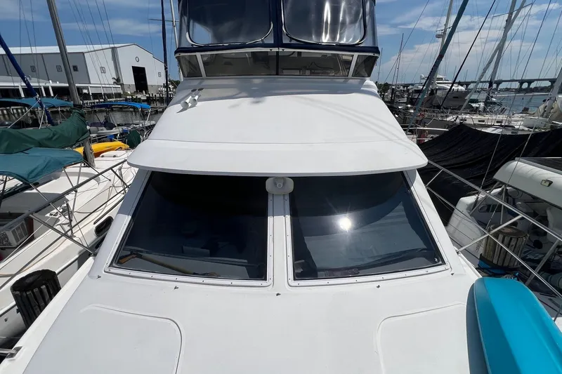 Slide: The Image of 1998 Cruisers Yachts 3650 Aft Cabin docked at marina, sunny day. - 1