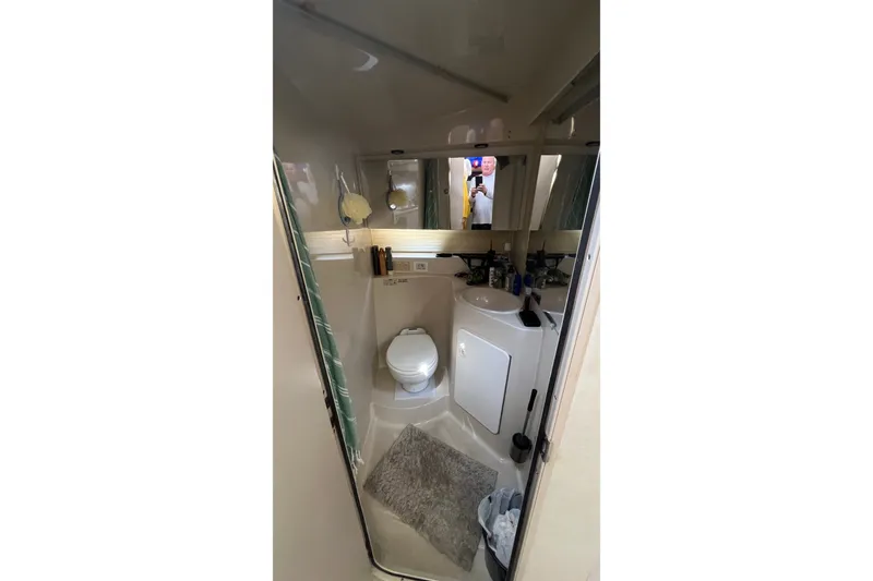 Slide: The Image of 1998 Cruisers Yachts 3650 Aft Cabin bathroom with toilet, sink, and mirror. - 33