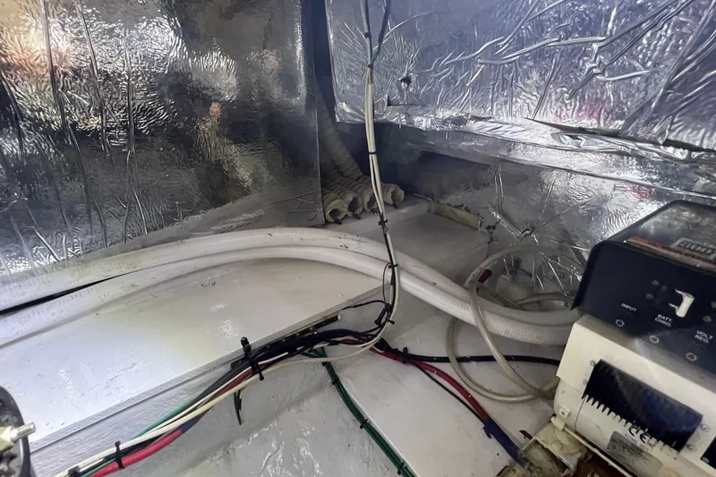 Slide: The Image of Engine room of 1998 Cruisers Yachts 3650 Aft Cabin with wiring and insulation. - 23