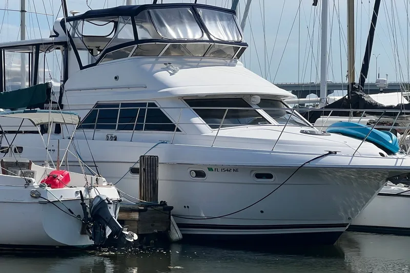 Slide: The Image of 1998 Cruisers Yachts 3650 Aft Cabin docked at marina, featuring sleek design and spacious cabin. - 0
