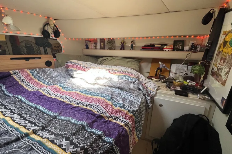 Slide: The Image of Cozy cabin interior of 1998 Cruisers Yachts 3650 Aft, with colorful bedding and decorations. - 39