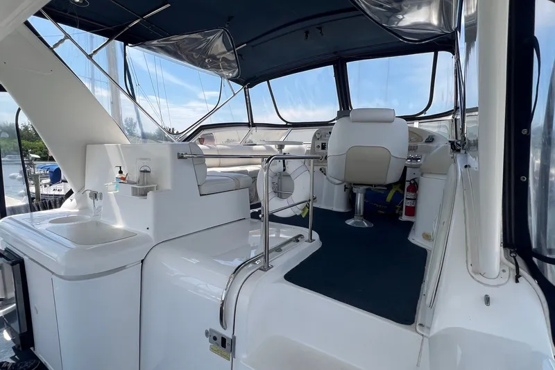 Slide: The Image of 1998 Cruisers Yachts 3650 Aft Cabin interior with helm, seating, and sink area. - 15