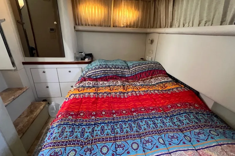 Slide: The Image of 1998 Cruisers Yachts 3650 Aft Cabin bedroom with colorful bedding and storage drawers. - 41