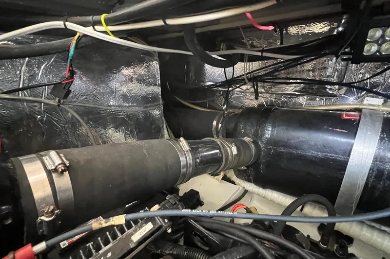 Slide: The Image of Engine compartment of a 1998 Cruisers Yachts 3650 Aft Cabin with visible wiring and hoses. - 18