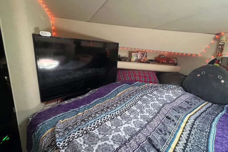 Slide: The Image of Cozy cabin interior of 1998 Cruisers Yachts 3650 Aft Cabin with TV and decorative bedding. - 38