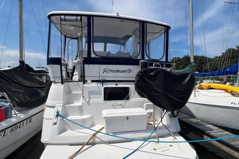 Slide: The Image of 1998 Cruisers Yachts 3650 Aft Cabin docked at marina under clear sky. - 7