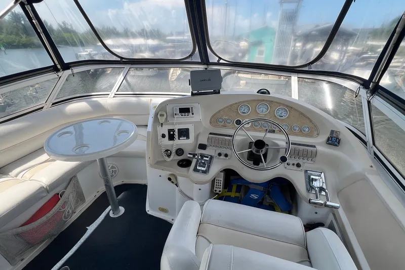 Slide: The Image of 1998 Cruisers Yachts 3650 Aft Cabin helm with steering wheel and navigation instruments. - 9