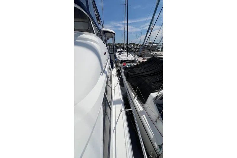 Slide: The Image of 1998 Cruisers Yachts 3650 Aft Cabin docked at marina, side view. - 4