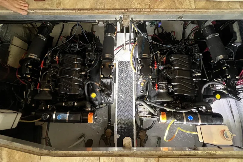 Slide: The Image of Engine compartment of a 1998 Cruisers Yachts 3650 Aft Cabin, showcasing dual engines. - 17