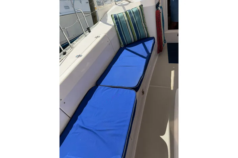 Slide: The Image of 2015 Catalina 445 sailboat cockpit with blue cushions and striped pillow. - 23