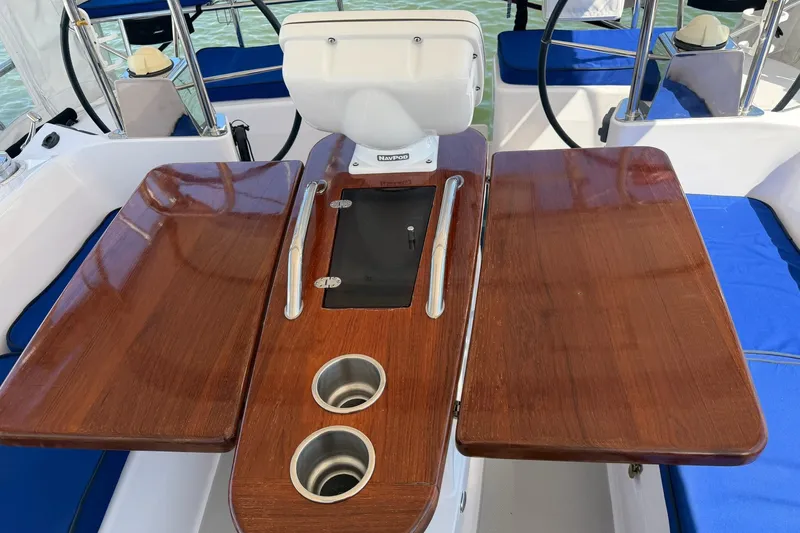 Slide: The Image of Cockpit of 2015 Catalina 445 sailboat with wooden table and blue seating. - 18