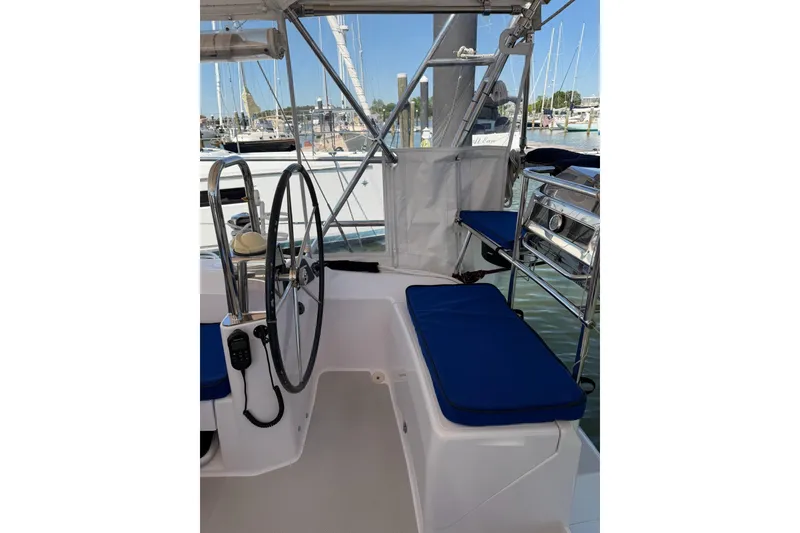Slide: The Image of Cockpit of 2015 Catalina 445 sailboat with blue cushions and steering wheel. - 9