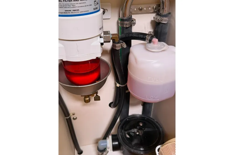 Slide: The Image of Engine compartment of a 2015 Catalina 445 sailboat, featuring fuel filter and hoses. - 33