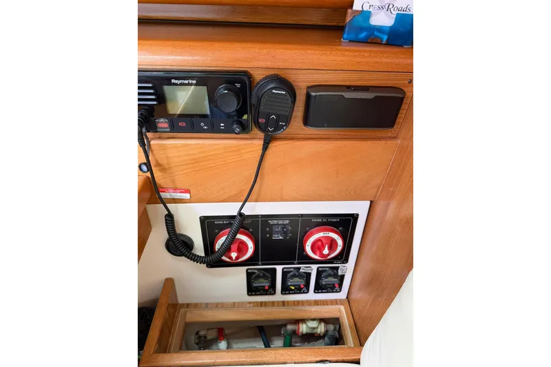 Slide: The Image of Control panel of a 2015 Catalina 445 sailboat with communication and power switches. - 43