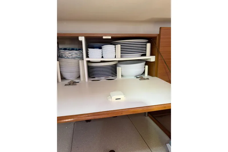 Slide: The Image of Cabinet in 2015 Catalina 445 yacht with neatly stacked dishes and bowls. - 52