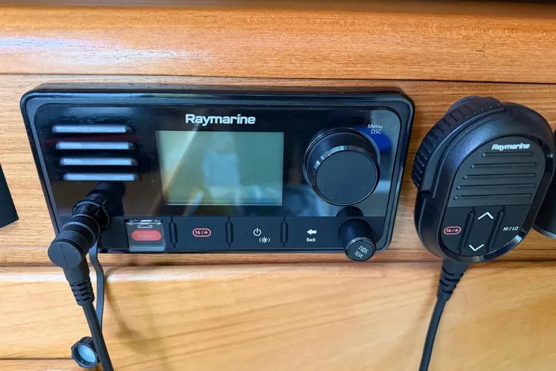 Slide: The Image of Raymarine marine radio system on a 2015 Catalina 445 sailboat, featuring a control panel and microphone. - 44