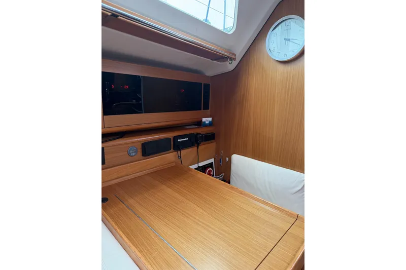 Slide: The Image of Interior of 2015 Catalina 445 sailboat with wooden table and navigation equipment. - 46