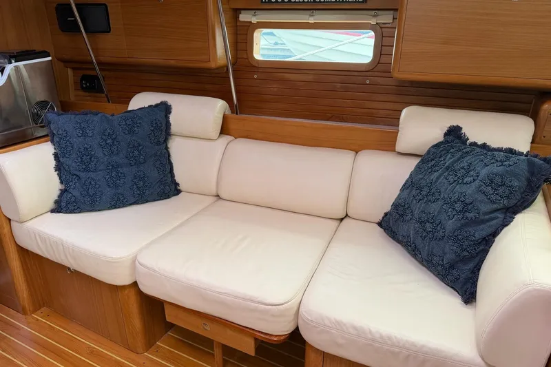 Slide: The Image of Cozy interior of 2015 Catalina 445 yacht with cream sofa and decorative blue pillows. - 38