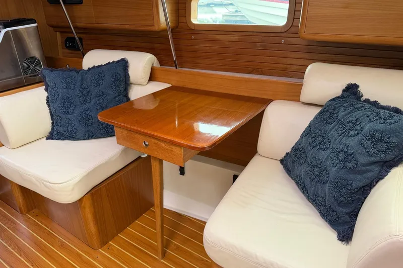 Slide: The Image of Interior of 2015 Catalina 445 yacht with cozy seating and wooden table. - 39