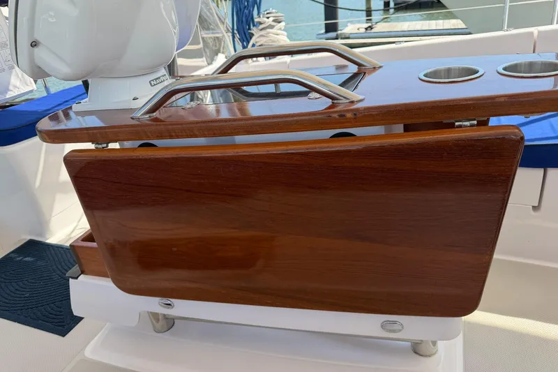 Slide: The Image of Cockpit table on a 2015 Catalina 445 sailboat with cup holders and polished wood finish. - 19