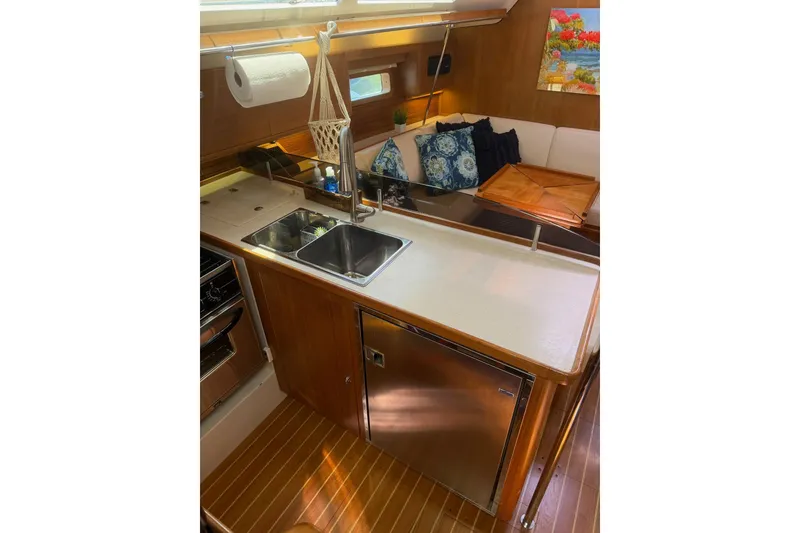 Slide: The Image of Interior of 2015 Catalina 445 yacht featuring a modern kitchen and cozy seating area. - 55