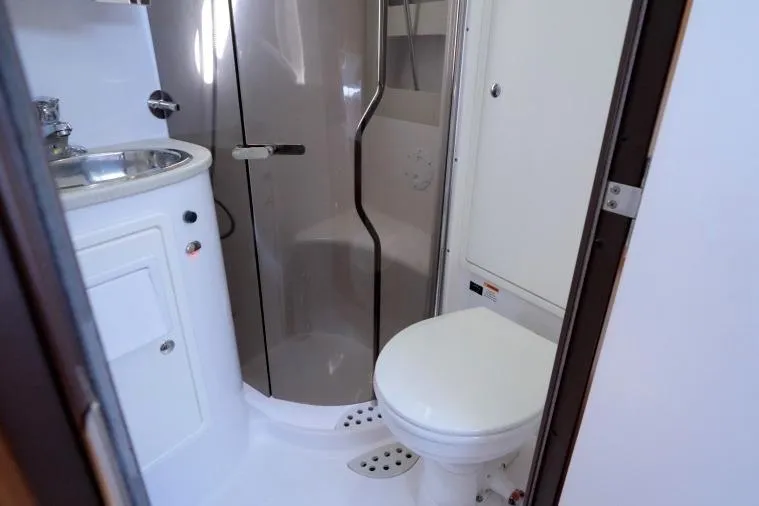 Slide: The Image of Bathroom interior of a 2015 Catalina 445 yacht, featuring a shower, sink, and toilet. - 59