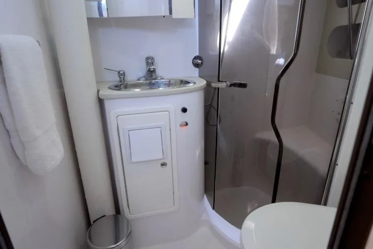 Slide: The Image of Bathroom interior of 2015 Catalina 445 yacht, featuring sink, shower, and towel. - 58