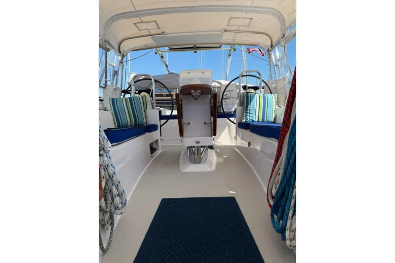 Slide: The Image of Interior view of a 2015 Catalina 445 sailboat cockpit with striped cushions and dual steering wheels. - 16