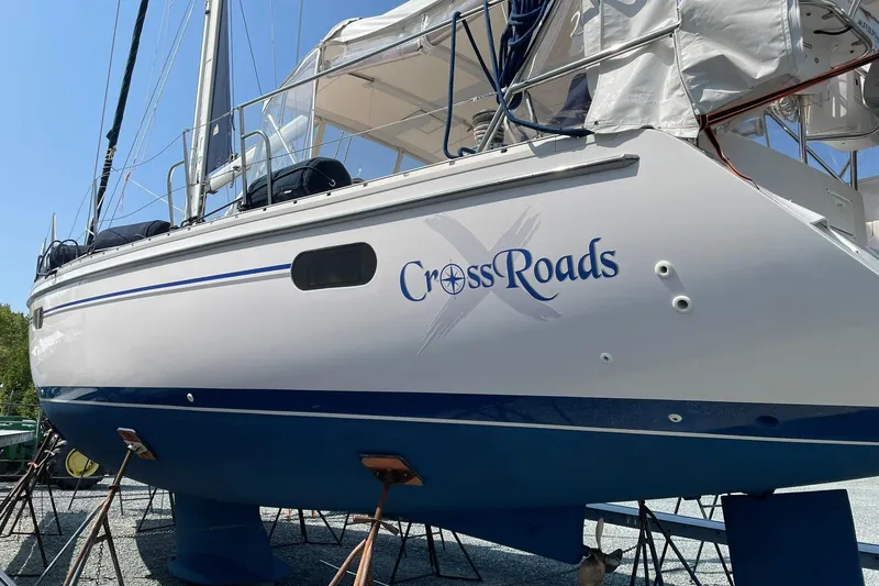 Slide: The Image of Catalina 445 sailboat named "CrossRoads" on stands, 2015 model, white and blue hull. - 5