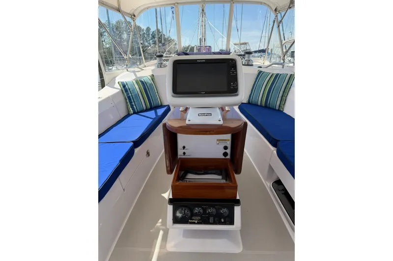 Slide: The Image of Cockpit of 2015 Catalina 445 sailboat with navigation equipment and blue cushioned seating. - 14
