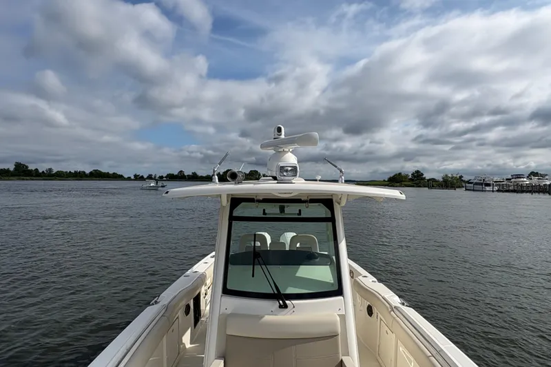 Slide: The Image of 2020 Boston Whaler 330 Outrage boat on calm water under cloudy sky. - 27