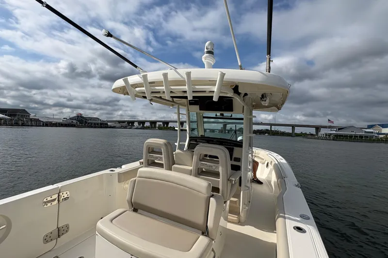 Slide: The Image of 2020 Boston Whaler 330 Outrage boat on water, featuring spacious seating and modern design. - 6