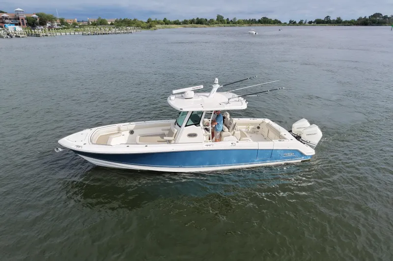 Slide: The Image of 2020 Boston Whaler 330 Outrage boat cruising on a calm river. - 3