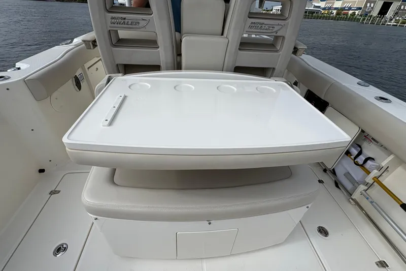 Slide: The Image of 2020 Boston Whaler 330 Outrage boat interior with seating and storage compartments. - 12