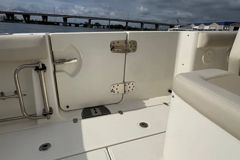 Slide: The Image of 2020 Boston Whaler 330 Outrage interior, featuring seating and a view of the water and bridge. - 19