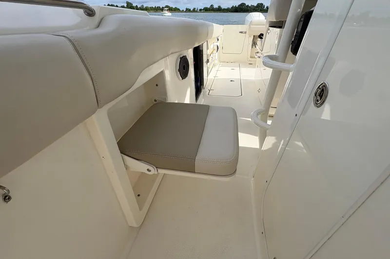 Slide: The Image of 2020 Boston Whaler 330 Outrage interior with foldable seat and sleek design. - 26
