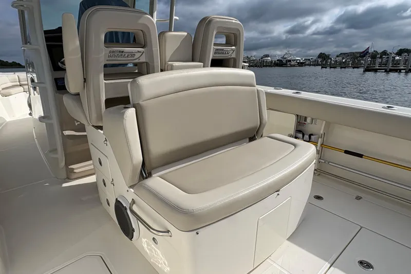 Slide: The Image of 2020 Boston Whaler 330 Outrage boat interior with comfortable seating and scenic waterfront view. - 11