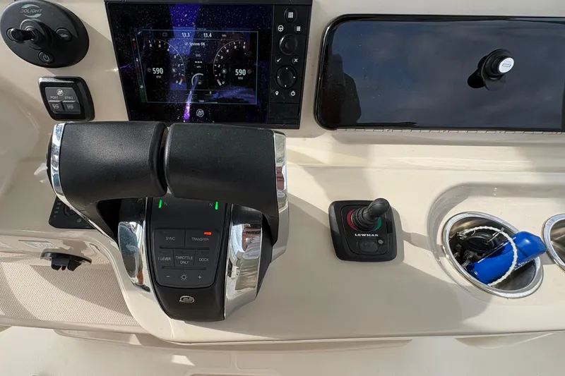 Slide: The Image of The image shows the helm of a 2020 Boston Whaler 330 Outrage with modern controls. - 17
