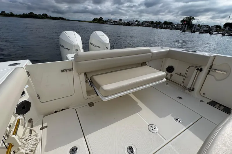 Slide: The Image of 2020 Boston Whaler 330 Outrage boat with Mercury engines, featuring a foldable rear seat. - 16